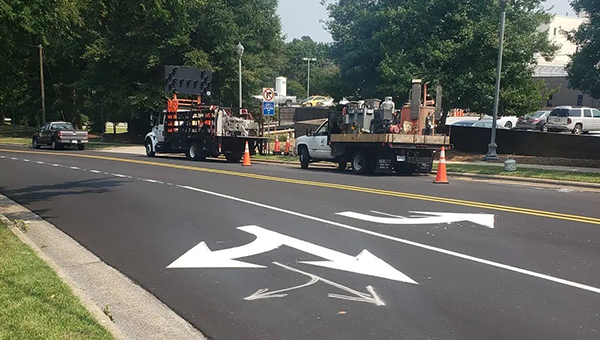 people at work on road markings